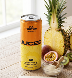 A can of JUCED collagen protein drink beside fresh fruit, representing a gut-friendly approach to protein
