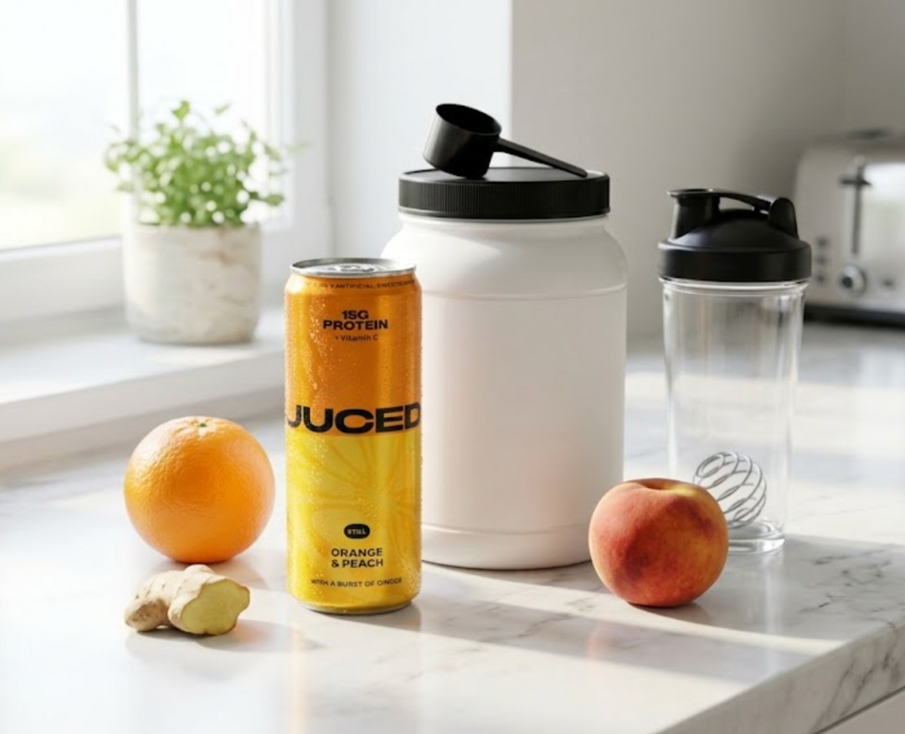 A can of JUCED protein drink next to a tub of protein powder and a shaker bottle on a kitchen counter, comparing the two protein formats