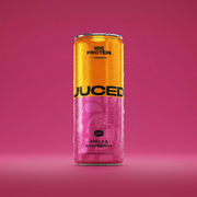 A can of JUCED collagen protein drink on a clean white surface with fruit ingredients alongside it 