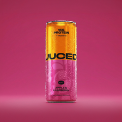A can of JUCED collagen protein drink on a clean white surface with fruit ingredients alongside it 