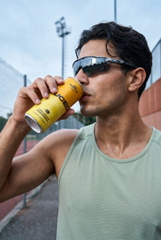 Man drinking a can of JUCED after a workout